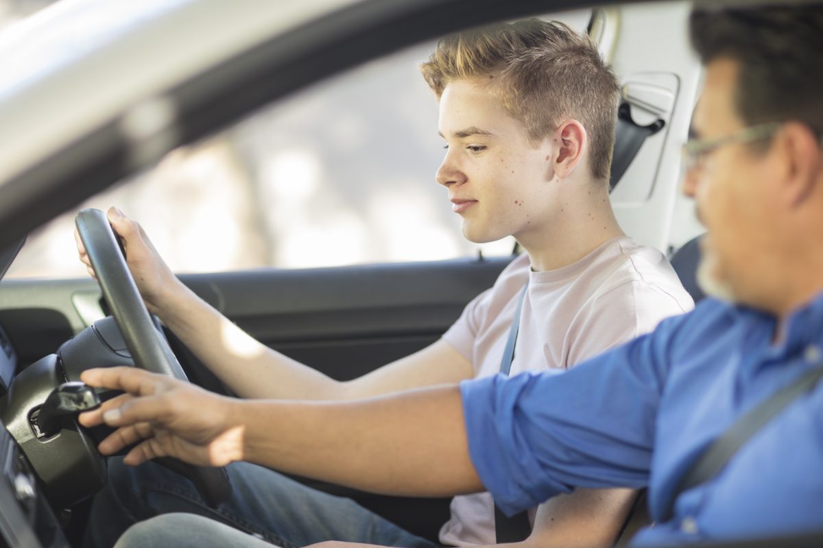 Young person behind the wheel learning to drive