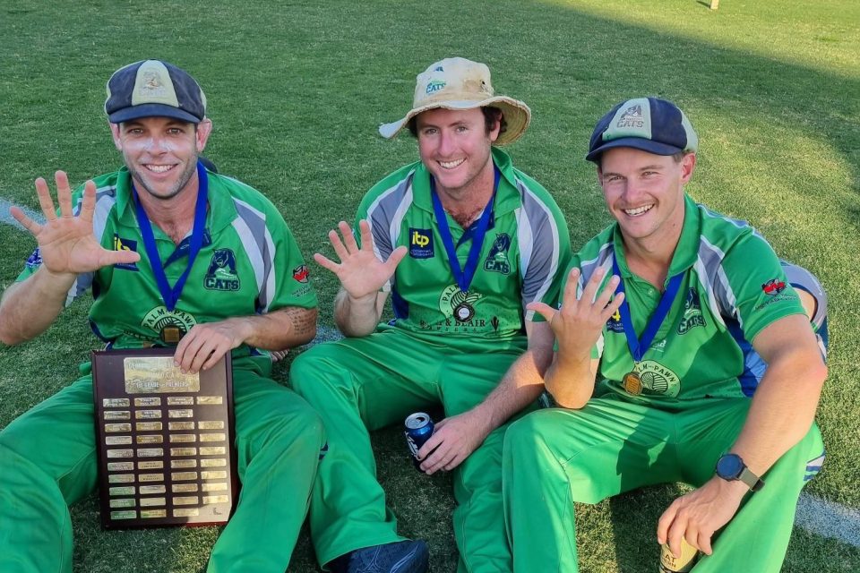 three cricketers with trophy