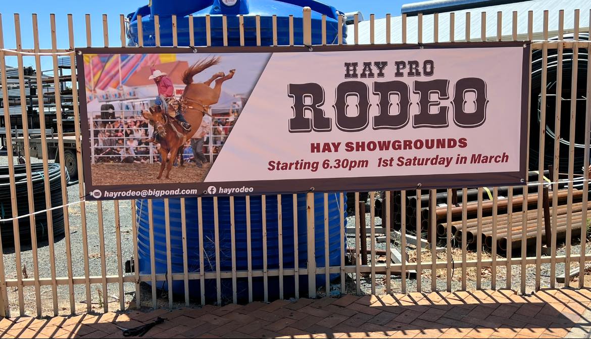 Banner for the Hay pro Rodeo hanging on a fence