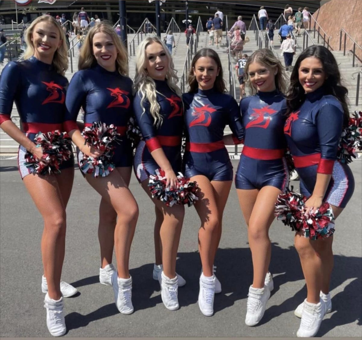 Six Roosters cheerleaders with pom poms
