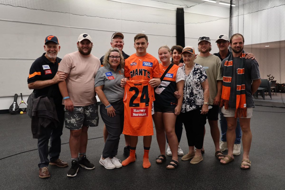 Harry Rowston with number 24 jersey and family 