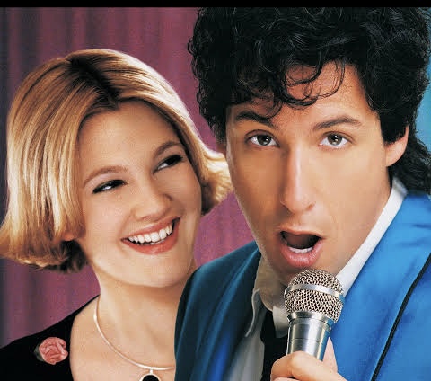 Adam Sandler with microphone next to Drew Barrymore