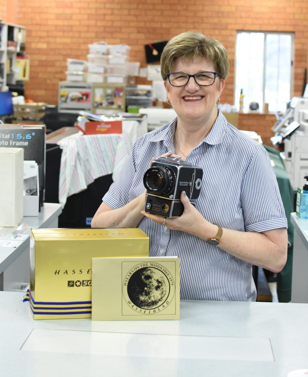 Louise Miller poses with moon landing camera