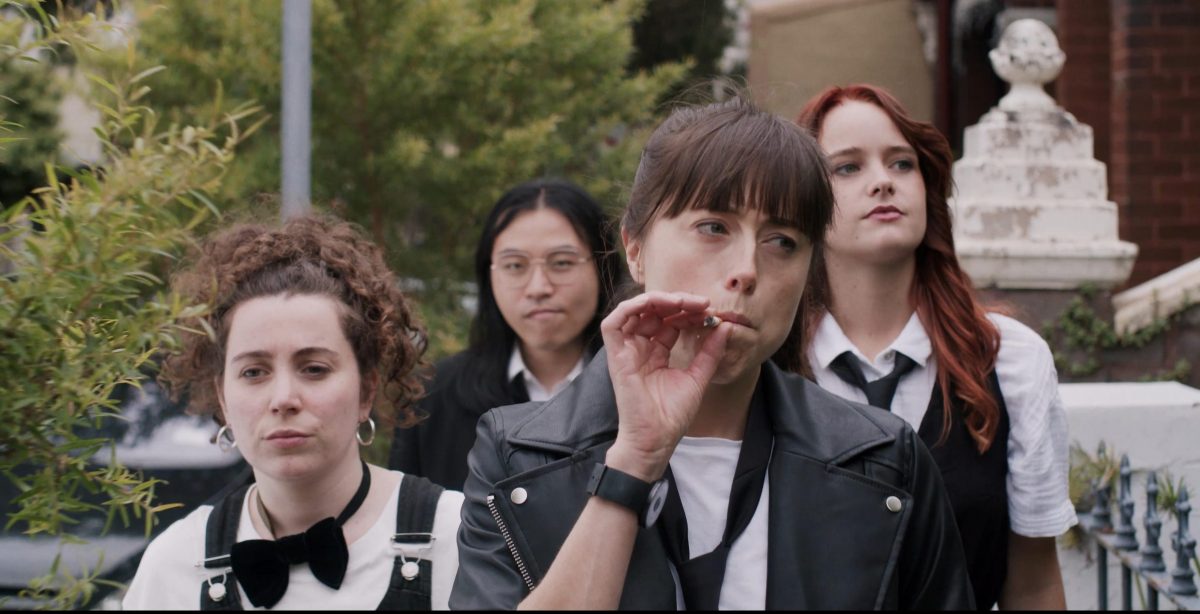 Woman smoking surrounded by three women