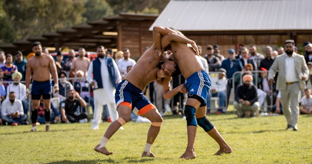Two men shirtless wrestling