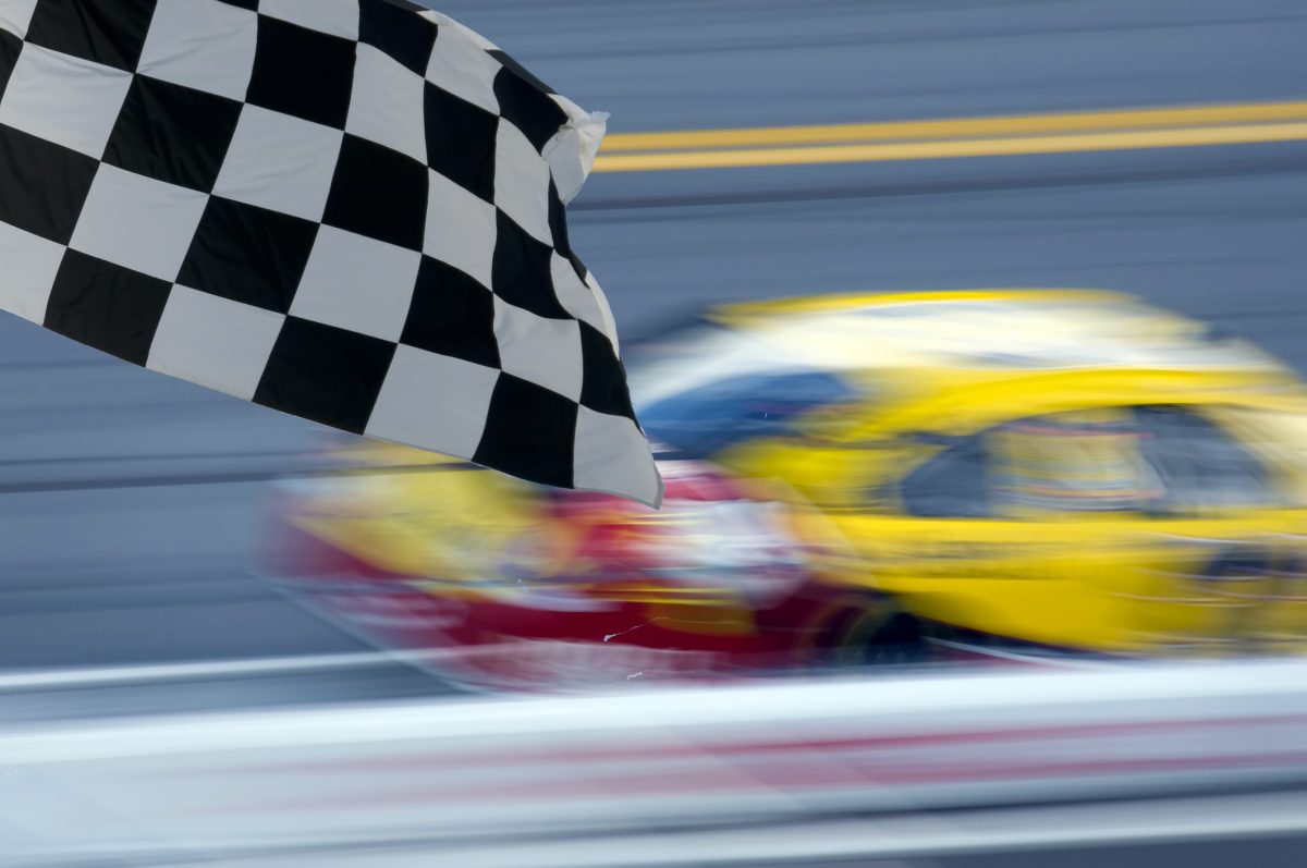 Chequered flag and blurred car