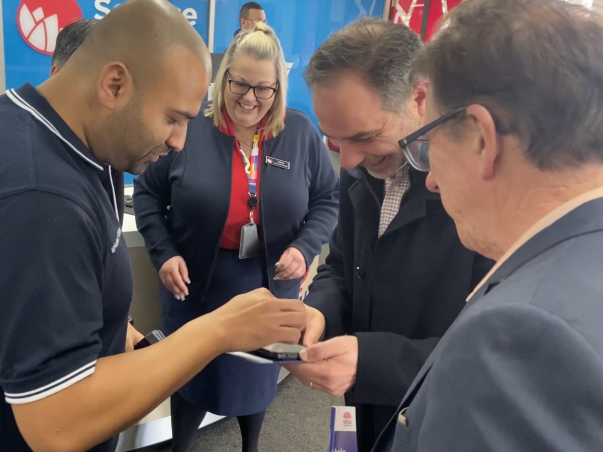 three men and a woman examining security technology