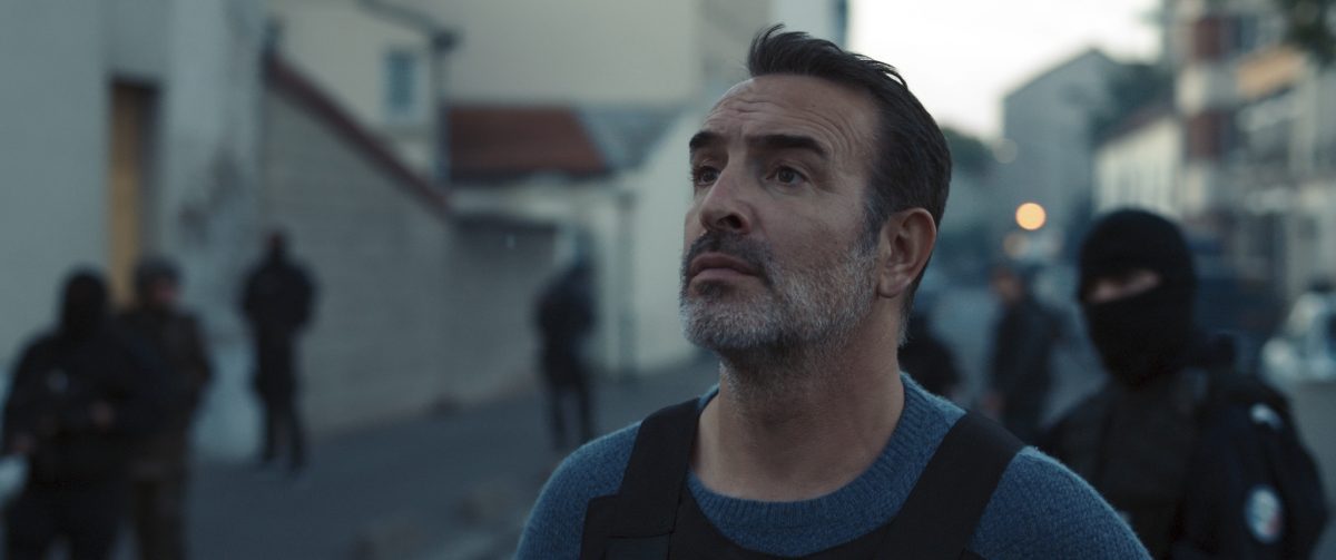 Still from November showing a policeman looking into the distance