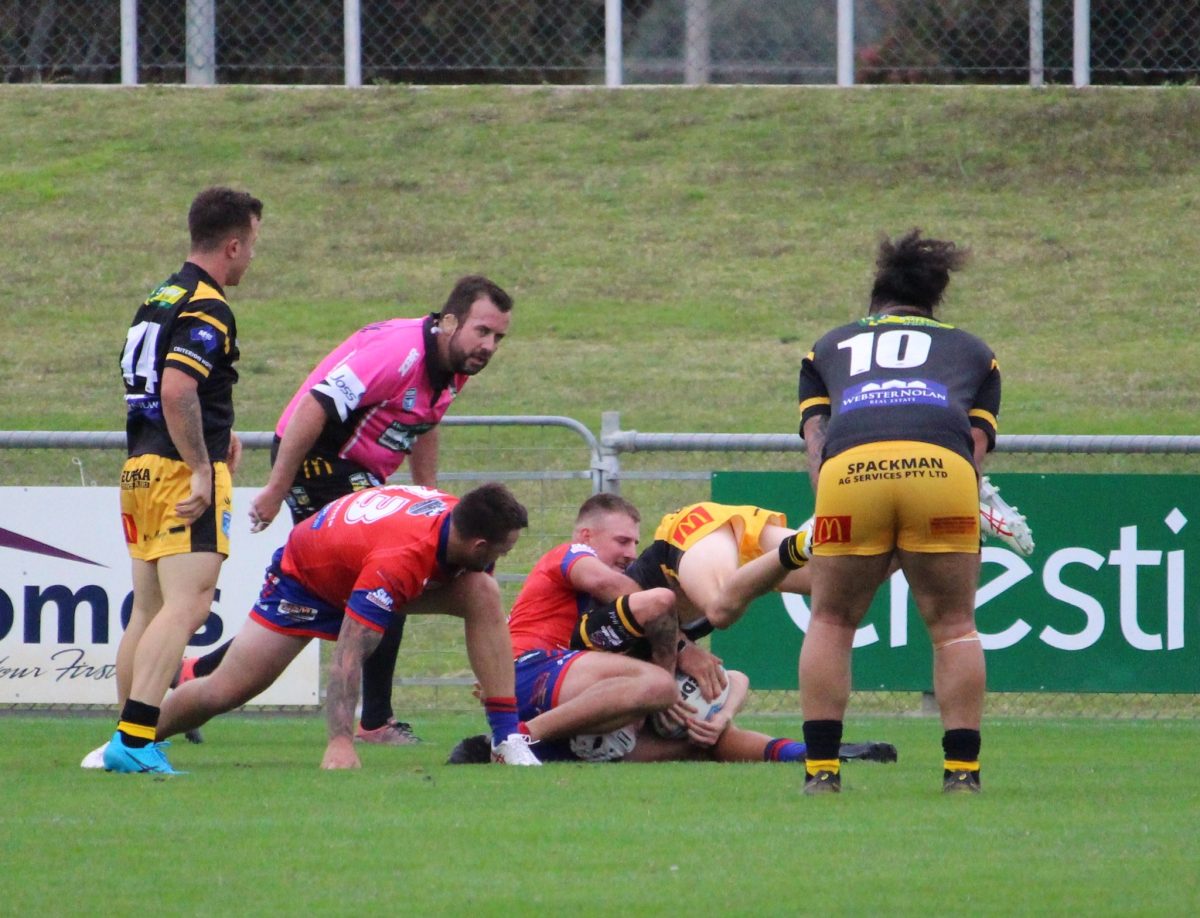 Group 9 referee, Ben Whitby, keeps a close eye on things as the Kangaroos tackle the Tigers