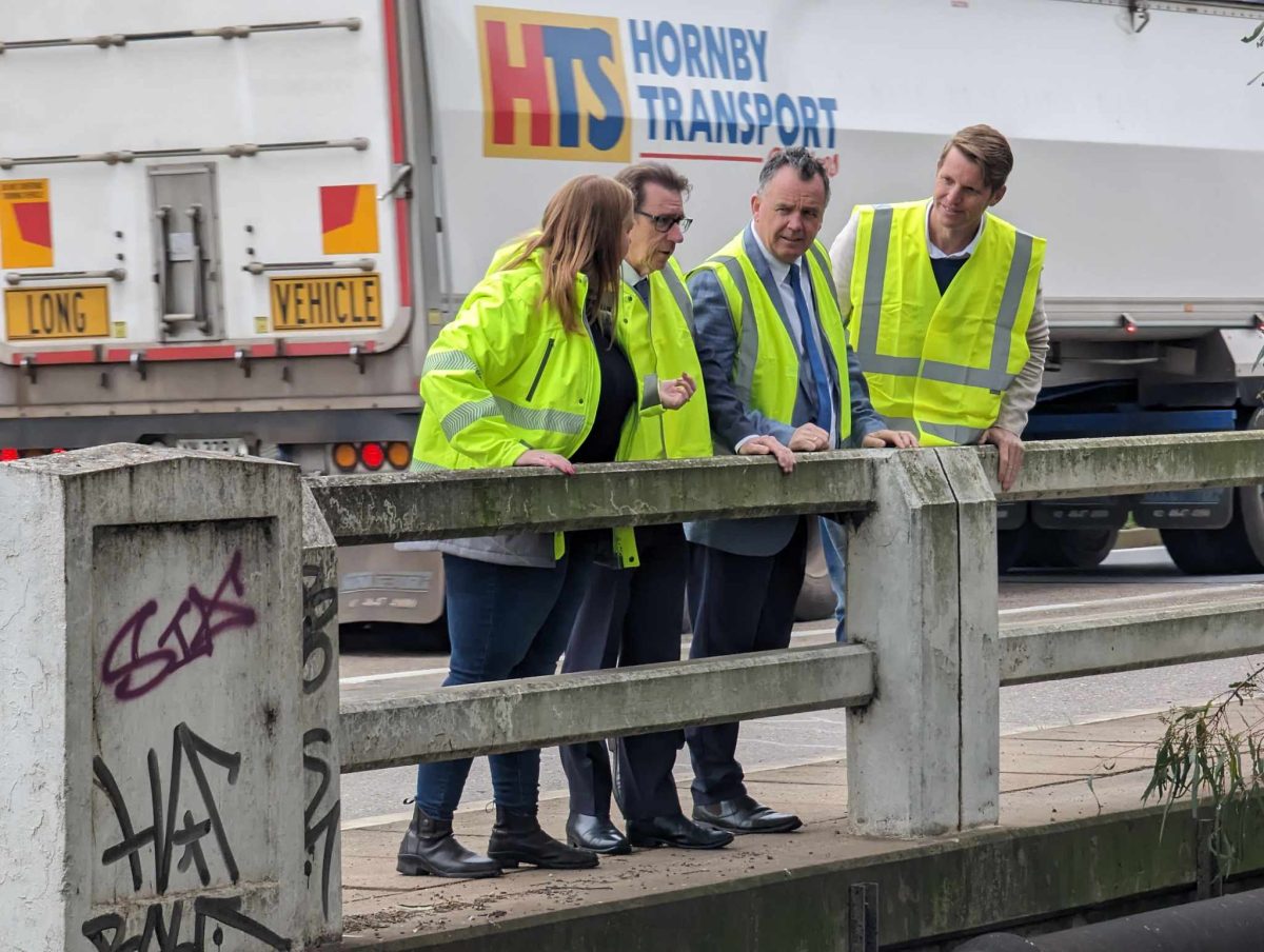 four politicians inspecting bridge