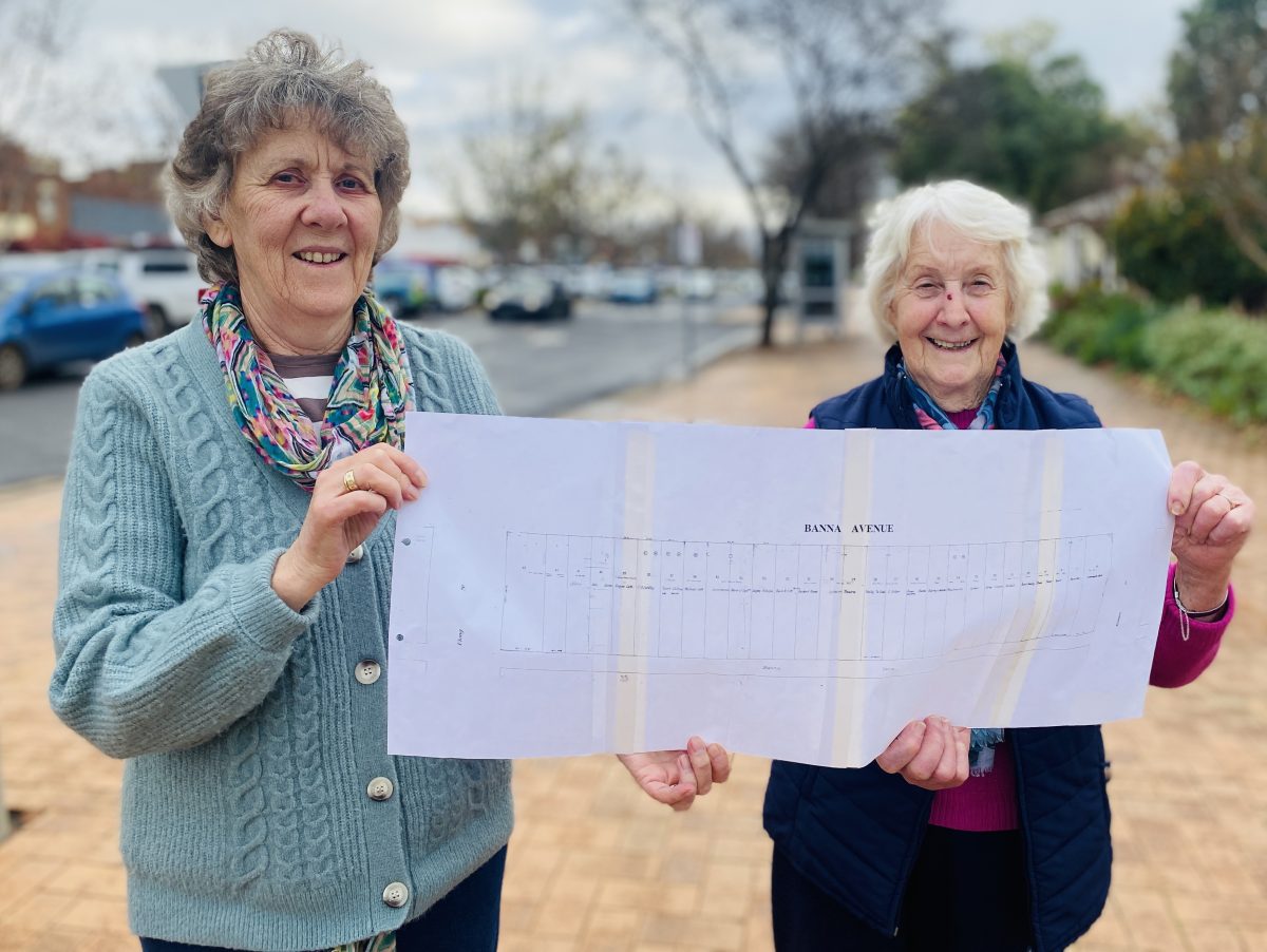 two women holding street map