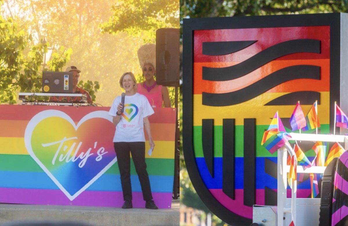 woman speaking on stage amid rainbow logos