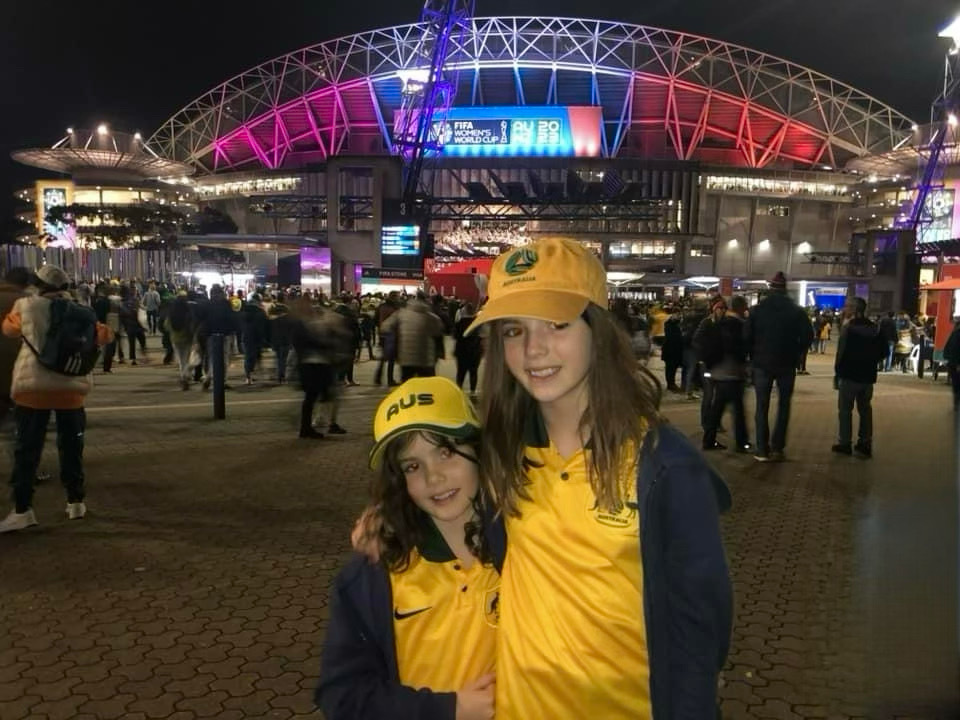 two girls outside soccer stadium