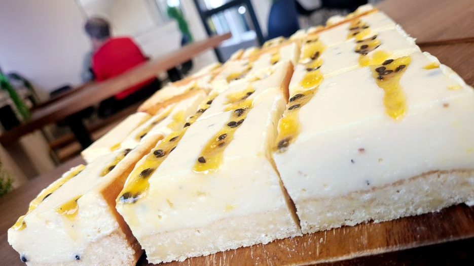 KAFE BLA9K has various delicious, sweet treats, including passionfruit cheesecake.