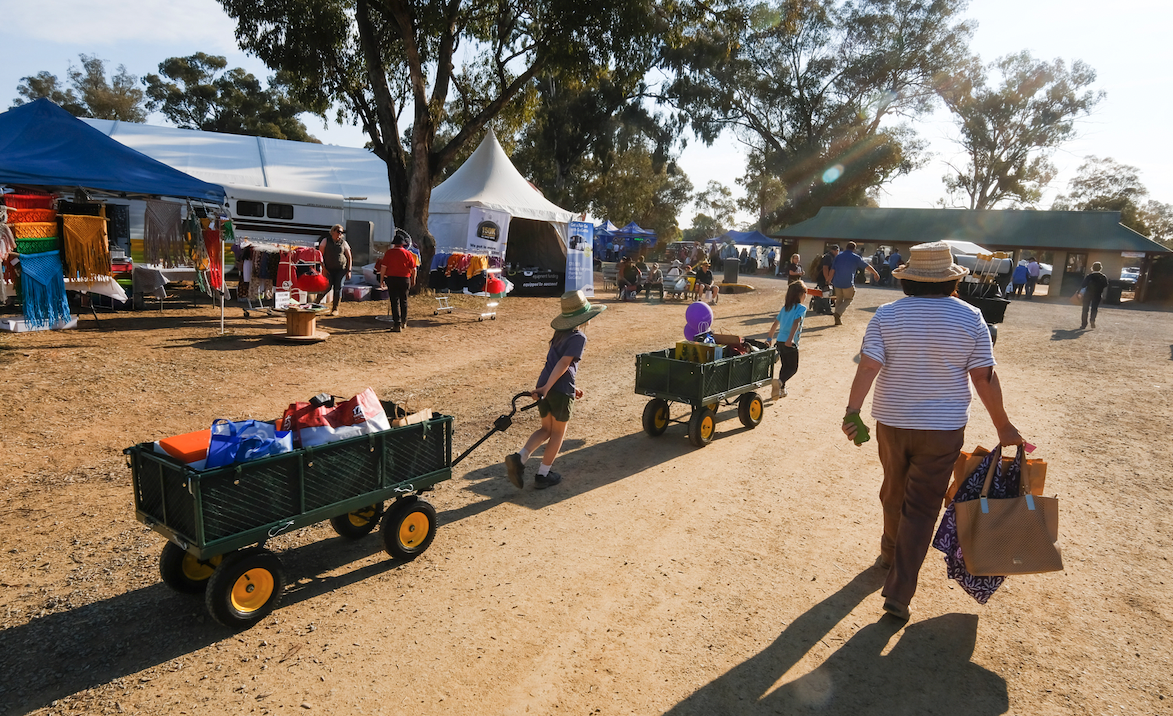 woman and kids with trolleys at country machinery show