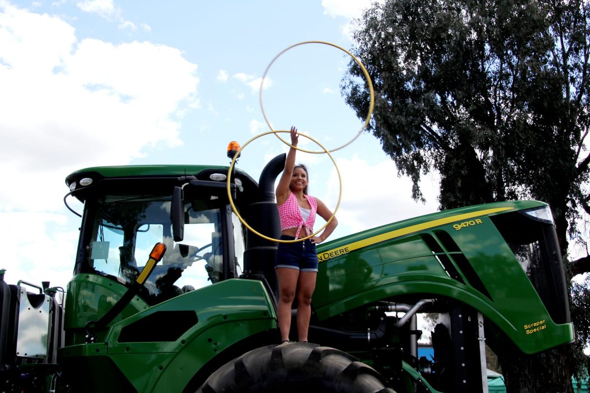 Circus artist with hoop on tractor