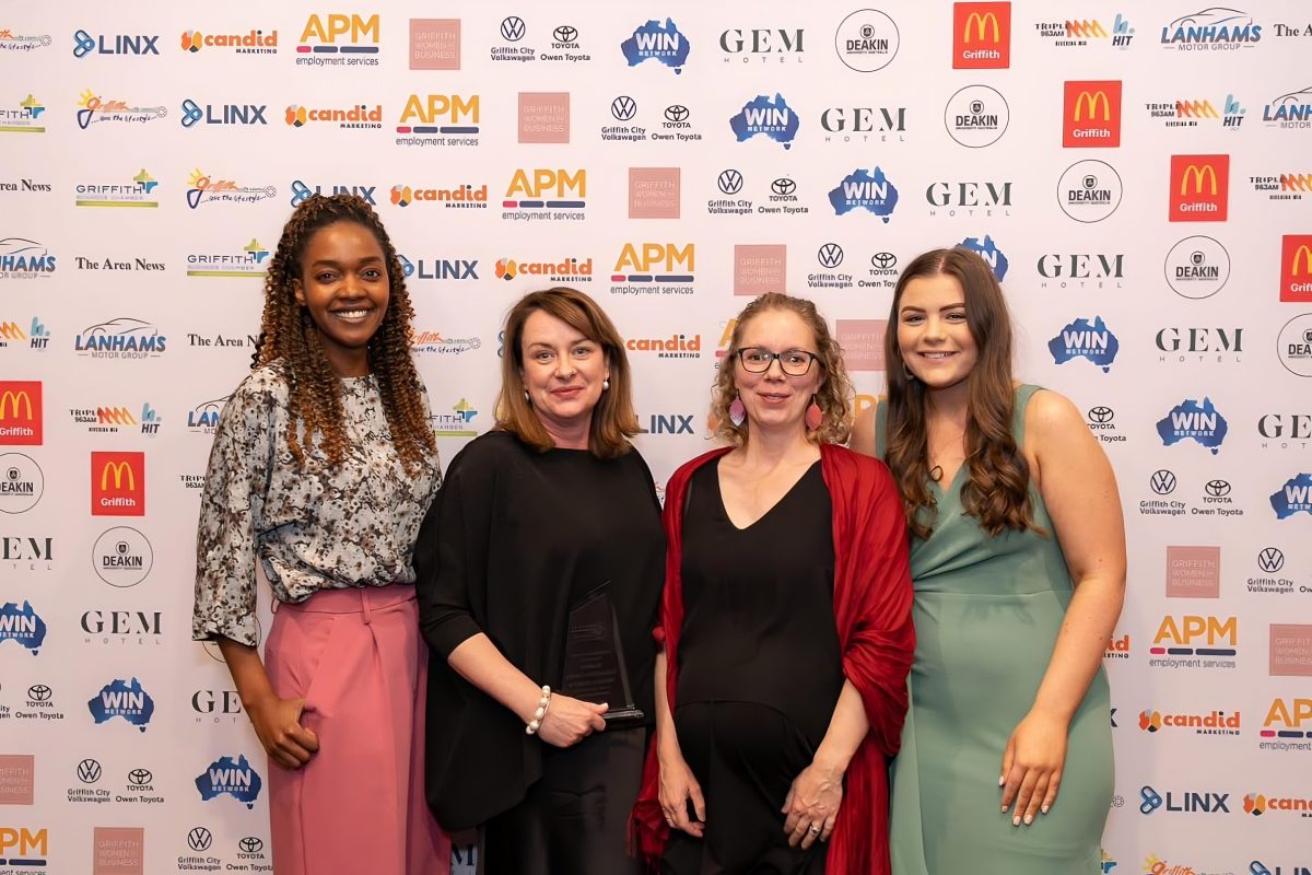 Four women pose for photo on award night 