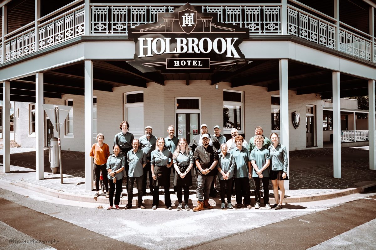 staff in front of renovated hotel