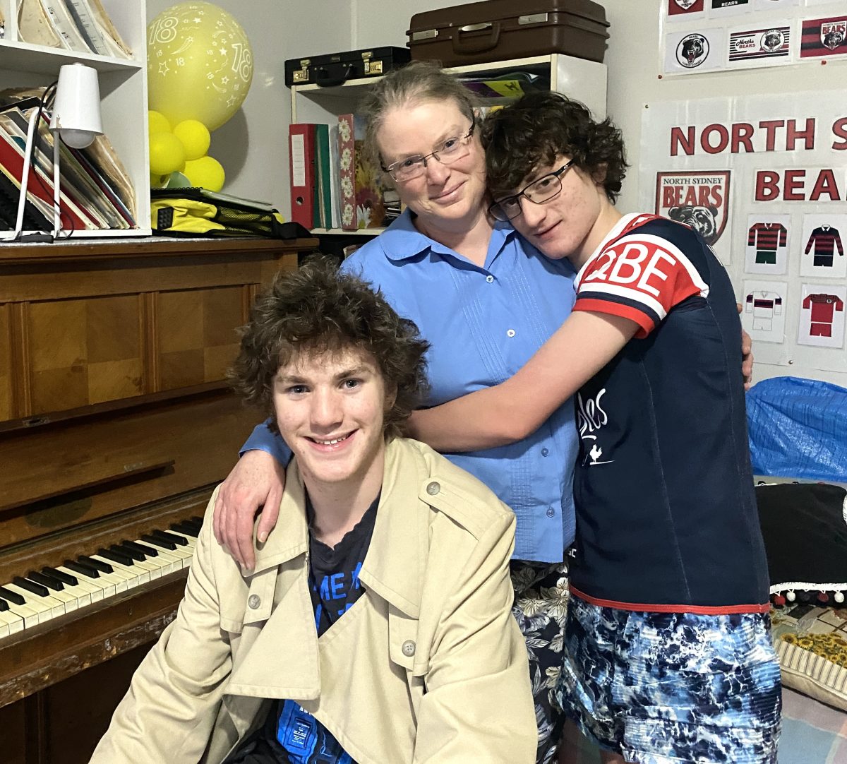Mum and two sons in front of piano 