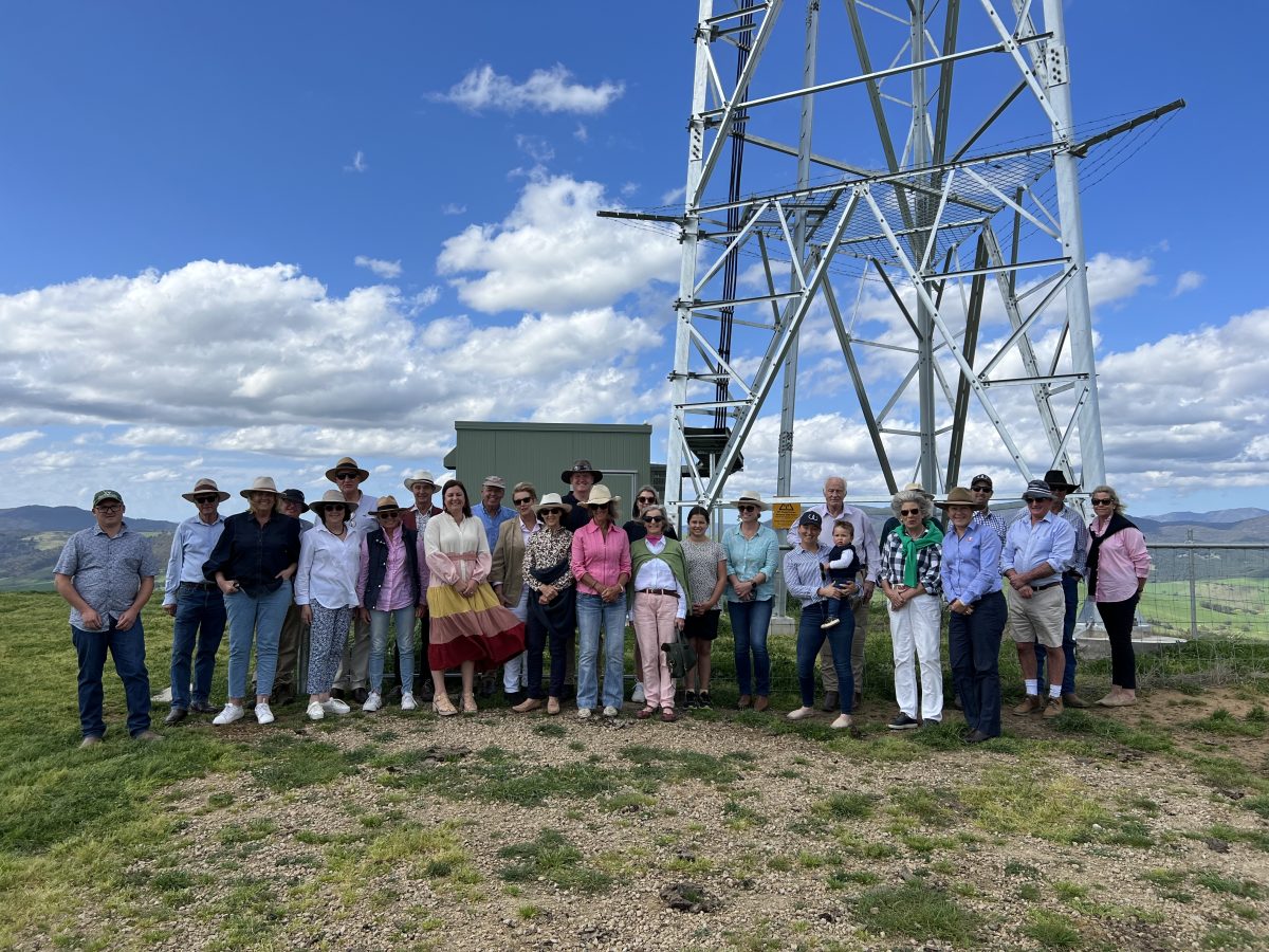 Tooma community members gather with Telstra representatives under blue skies to launch the town's very own tower