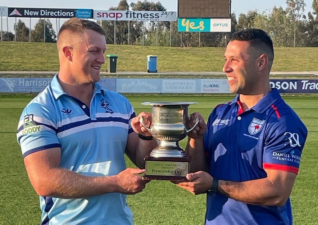 two rugby league players with trophy