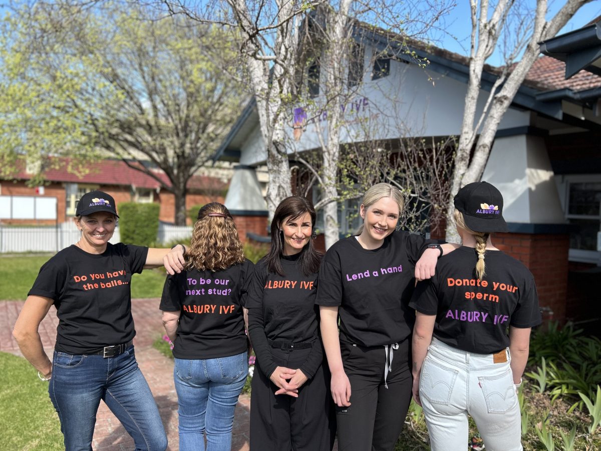 five nurses standing in a row with IVF message on T-shirts