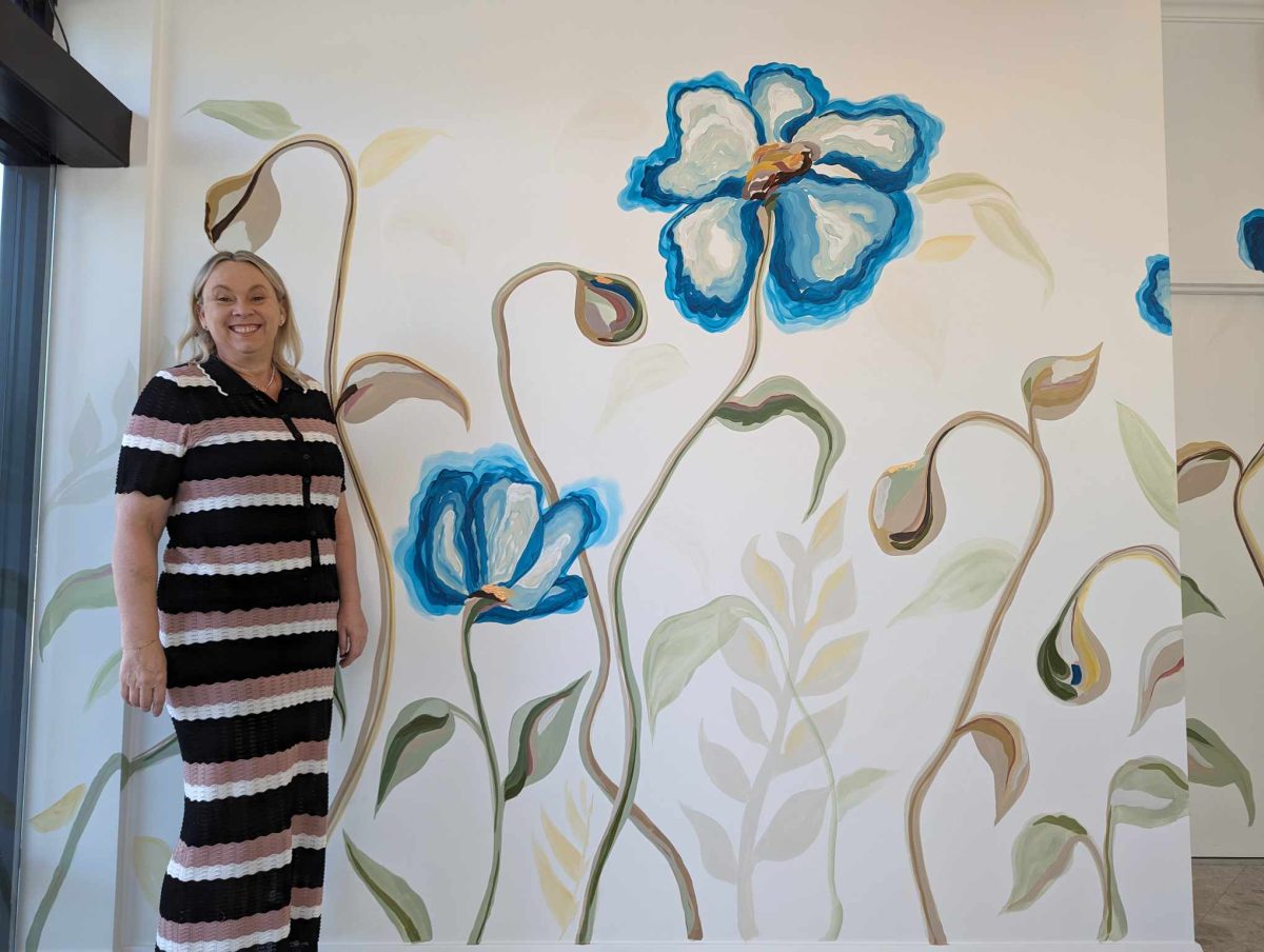 artist with her hotel mural