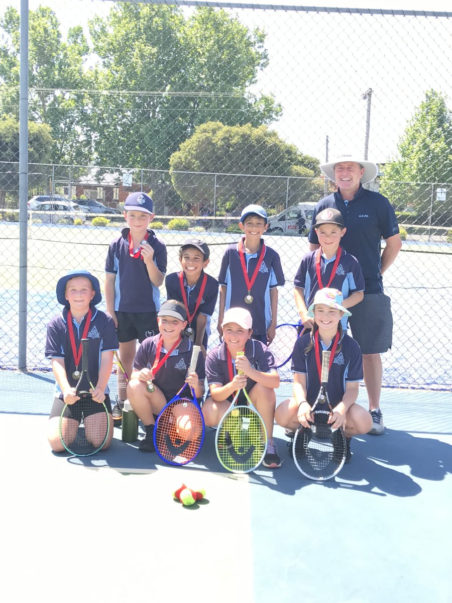 man and group of tennis kids with medals