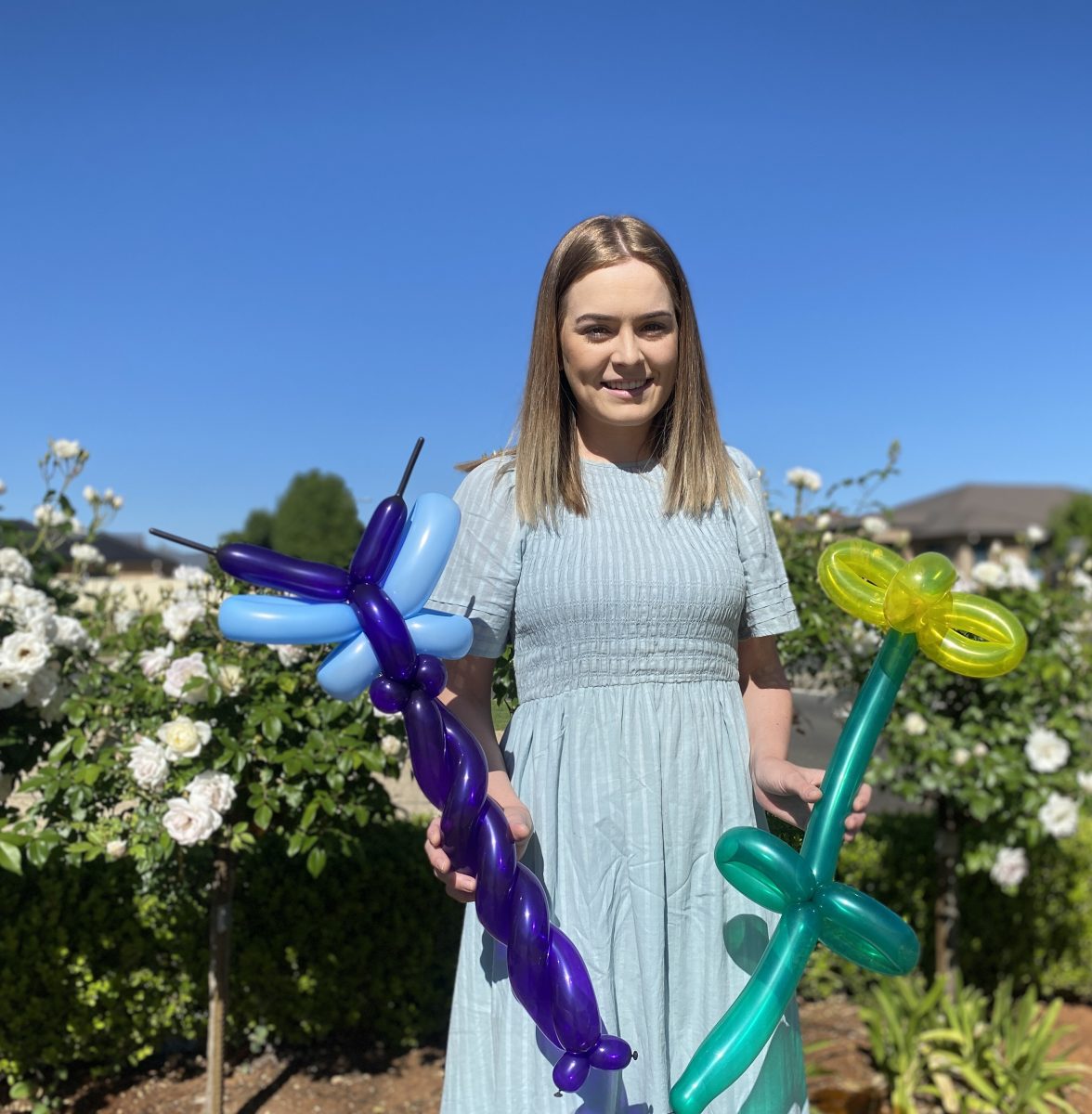 Brooke Drayton holds balloon designs 