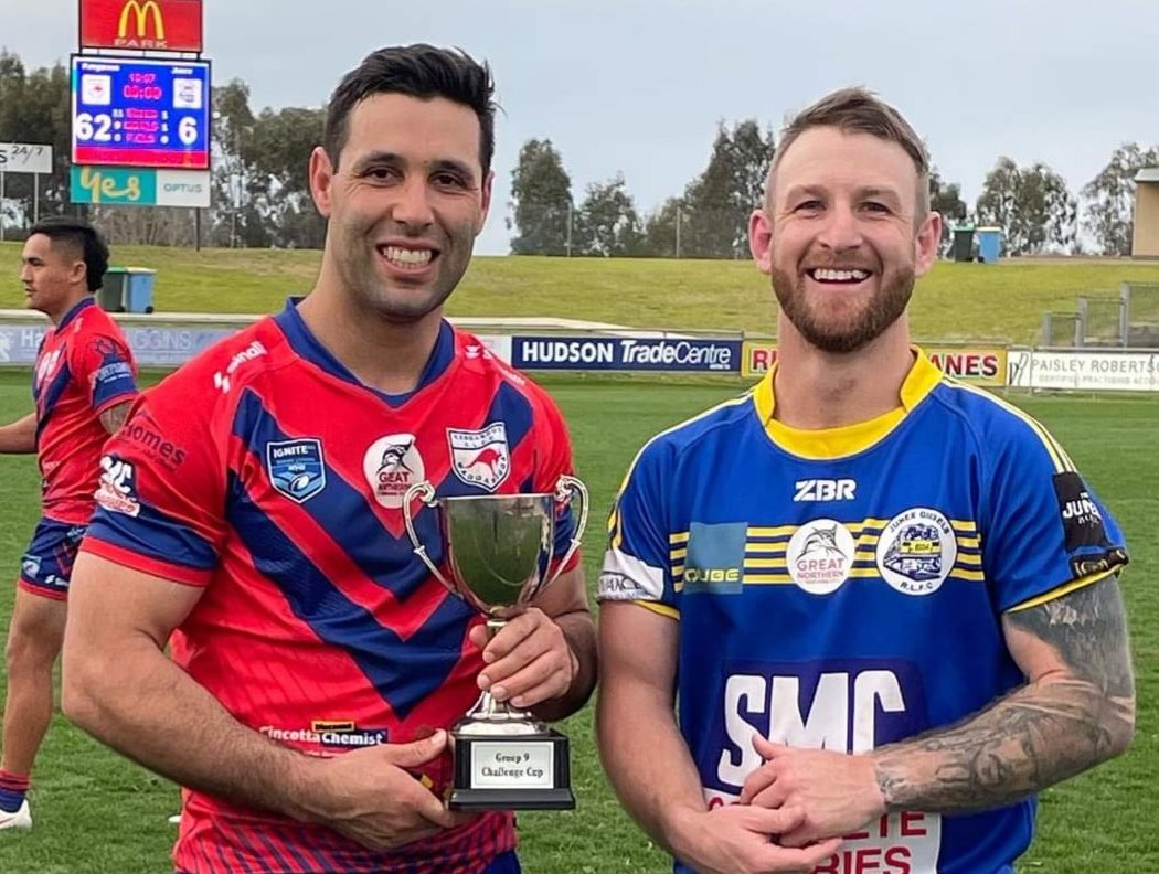 two rugby league players and trophy