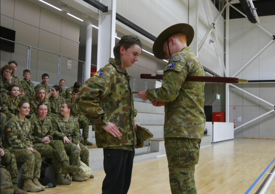 Toby Holt's fellow cadets from 219 ACU watch on as RSM Evan Hookway promotes him to CDTLCPL.