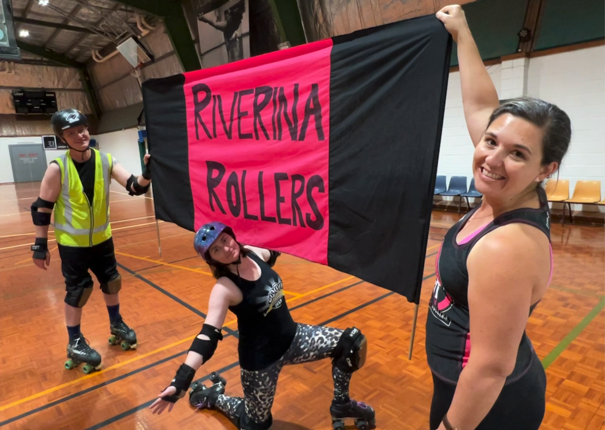roller derby skaters with banner