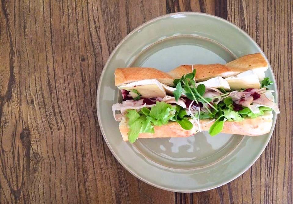 Turkey brie baguette with turkey breast, brie, cranberry sauce, lettuce, alfalfa sprouts.
