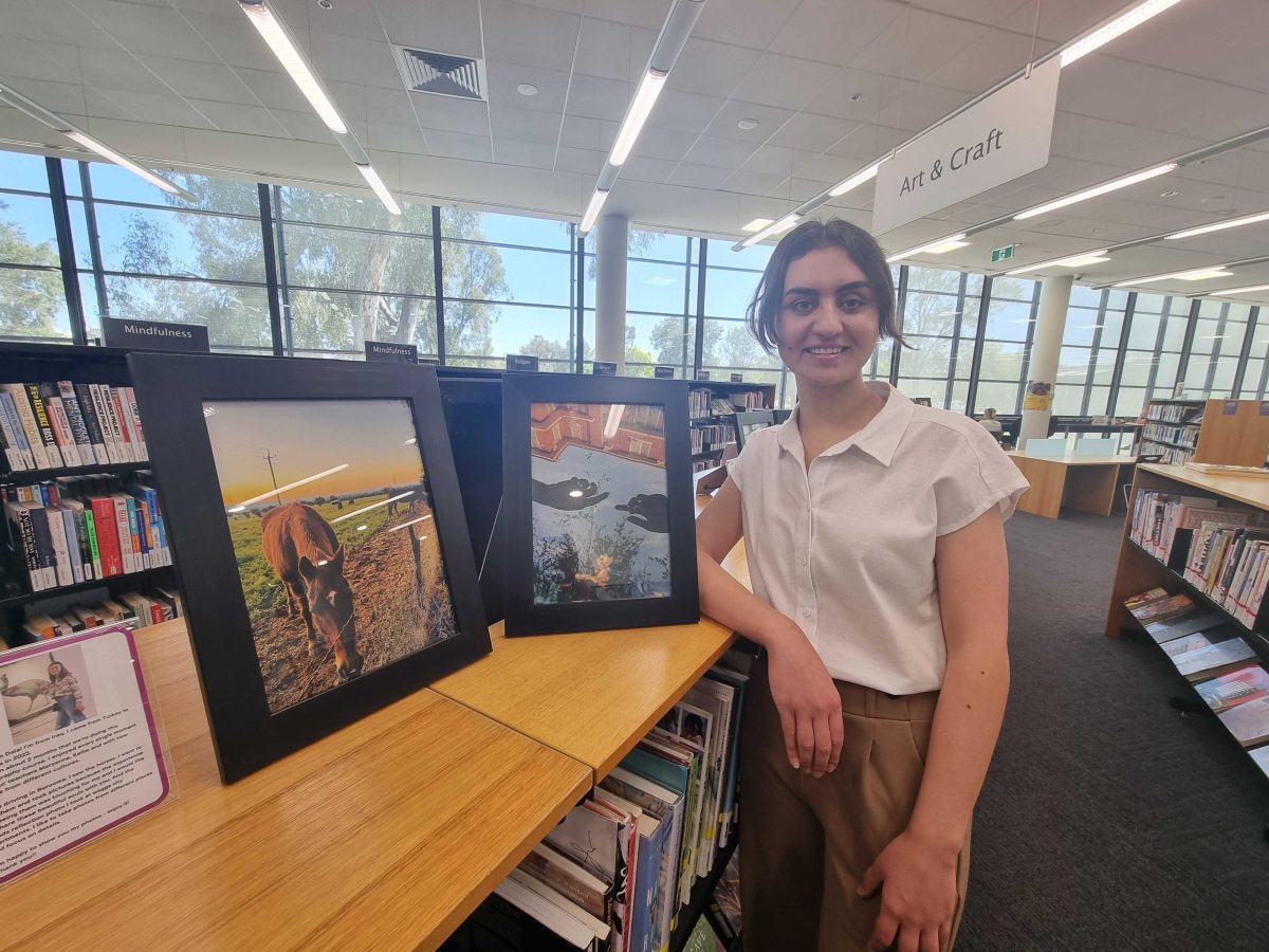 woman with photos in library