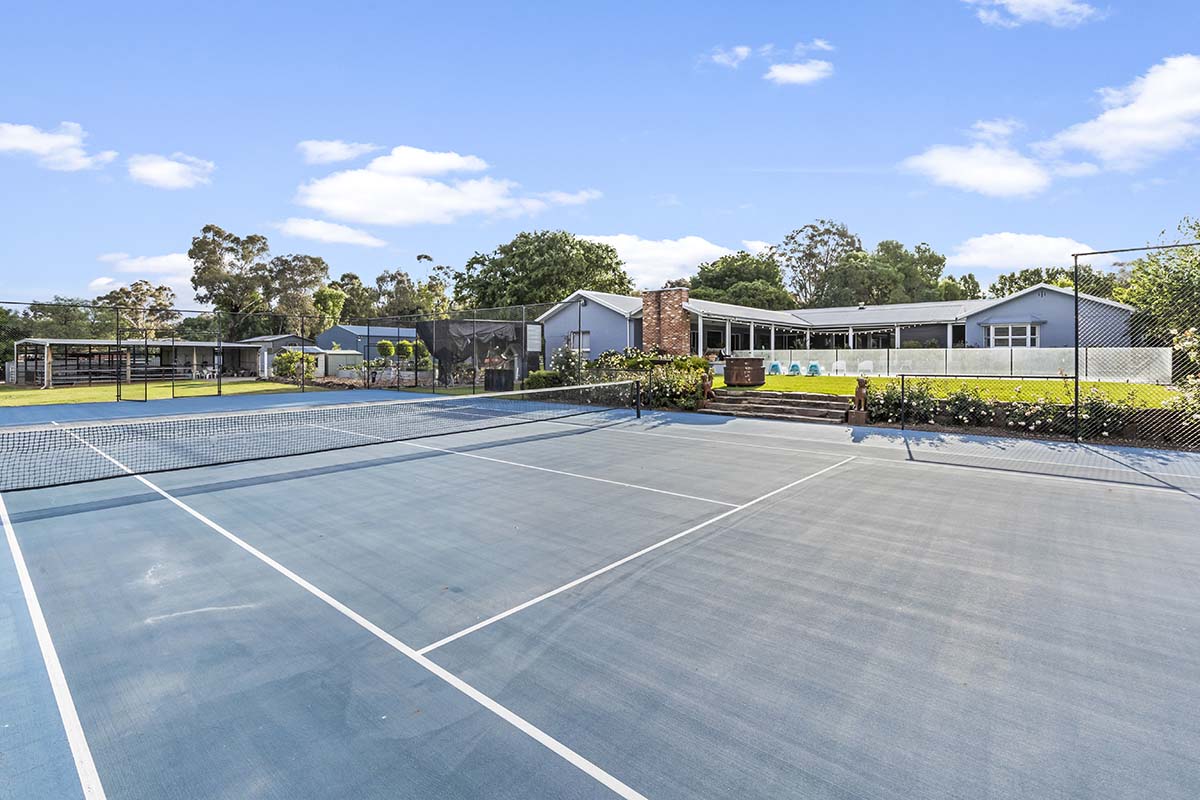 Tennis court in front of house