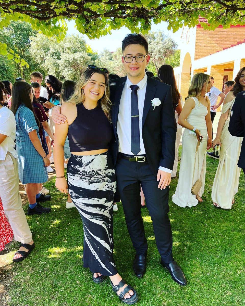 Noah in a suit with his sister 