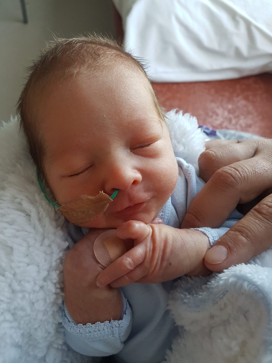 newborn boy with tube in nostril