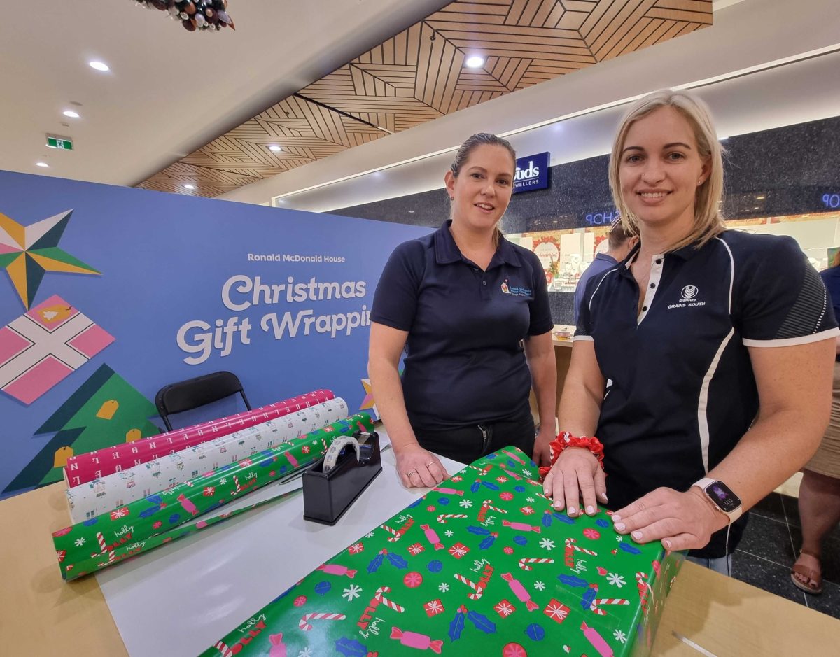 woman with volunteer gift wrapper