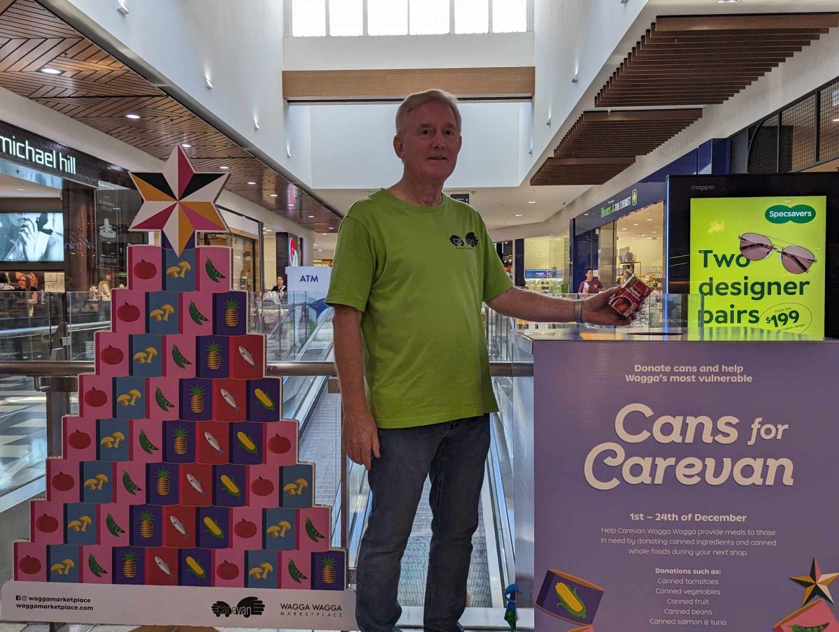 man at shopping centre charity display