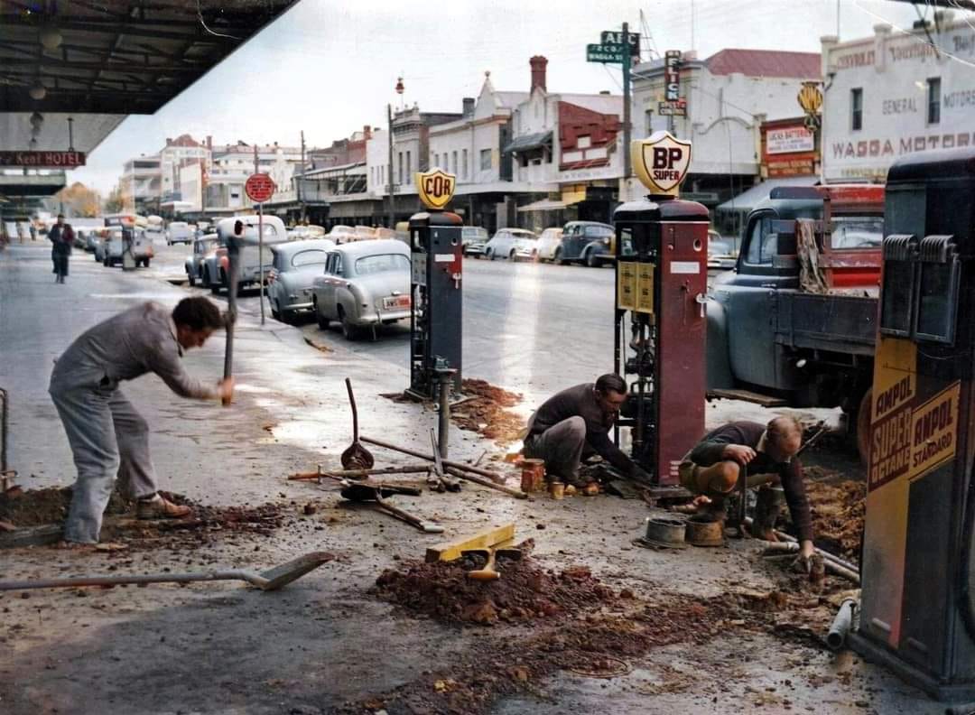 workmen removing petrol bowsers from street