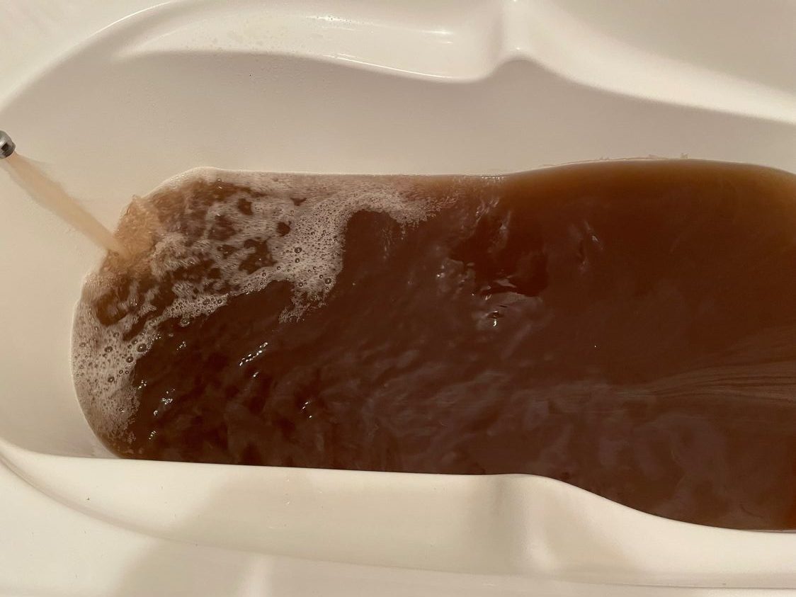 Brown water in a bathtub