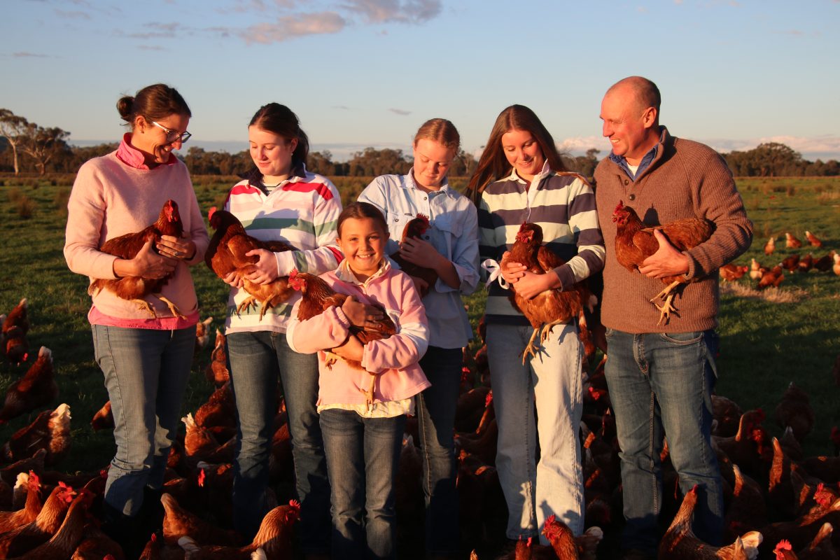 Family of six people, all holding a chicken