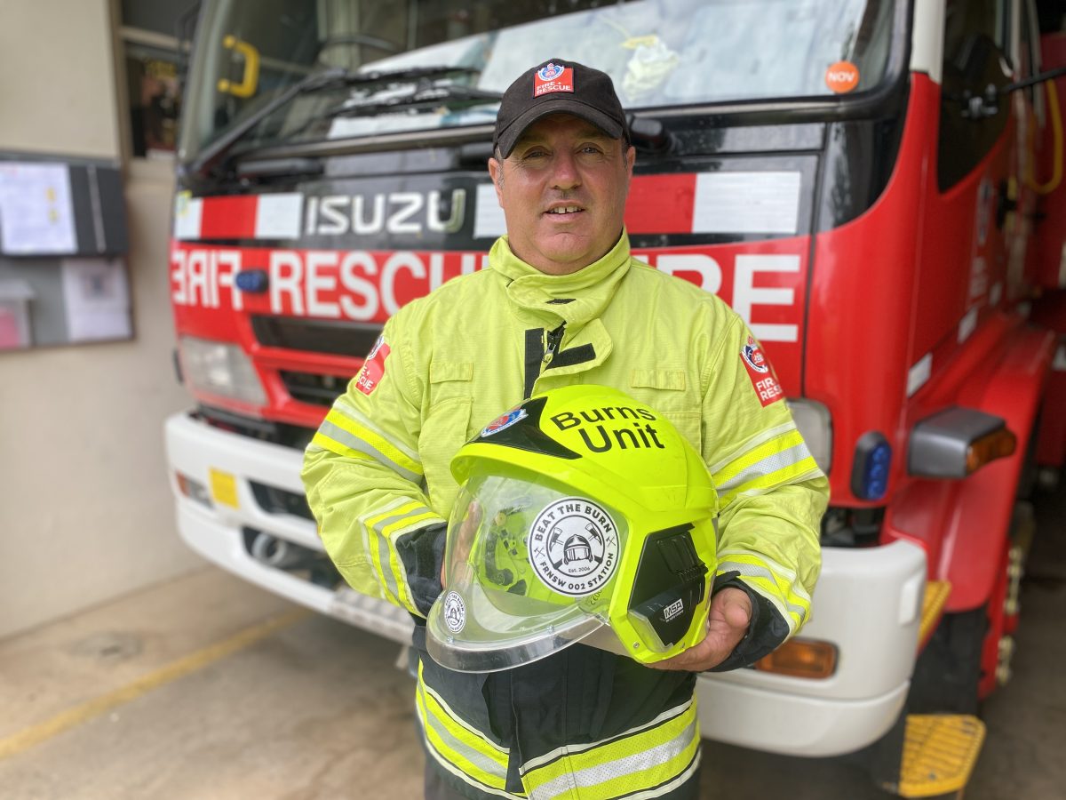 firefighter holding helmet