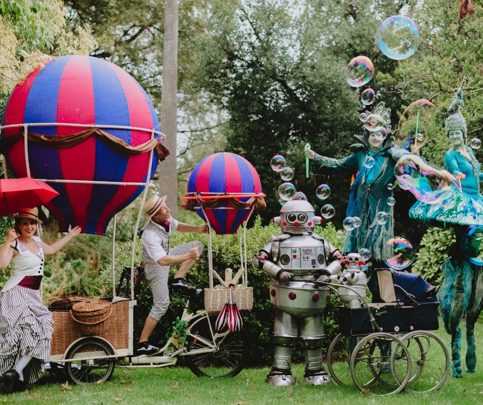 costumed festival characters with props in garden