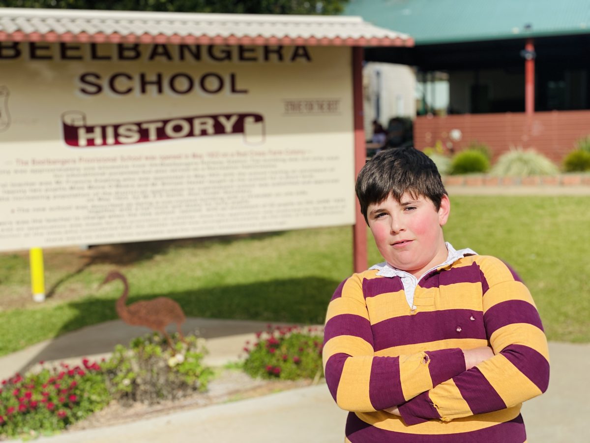 Barry Romeo in front of school sign 