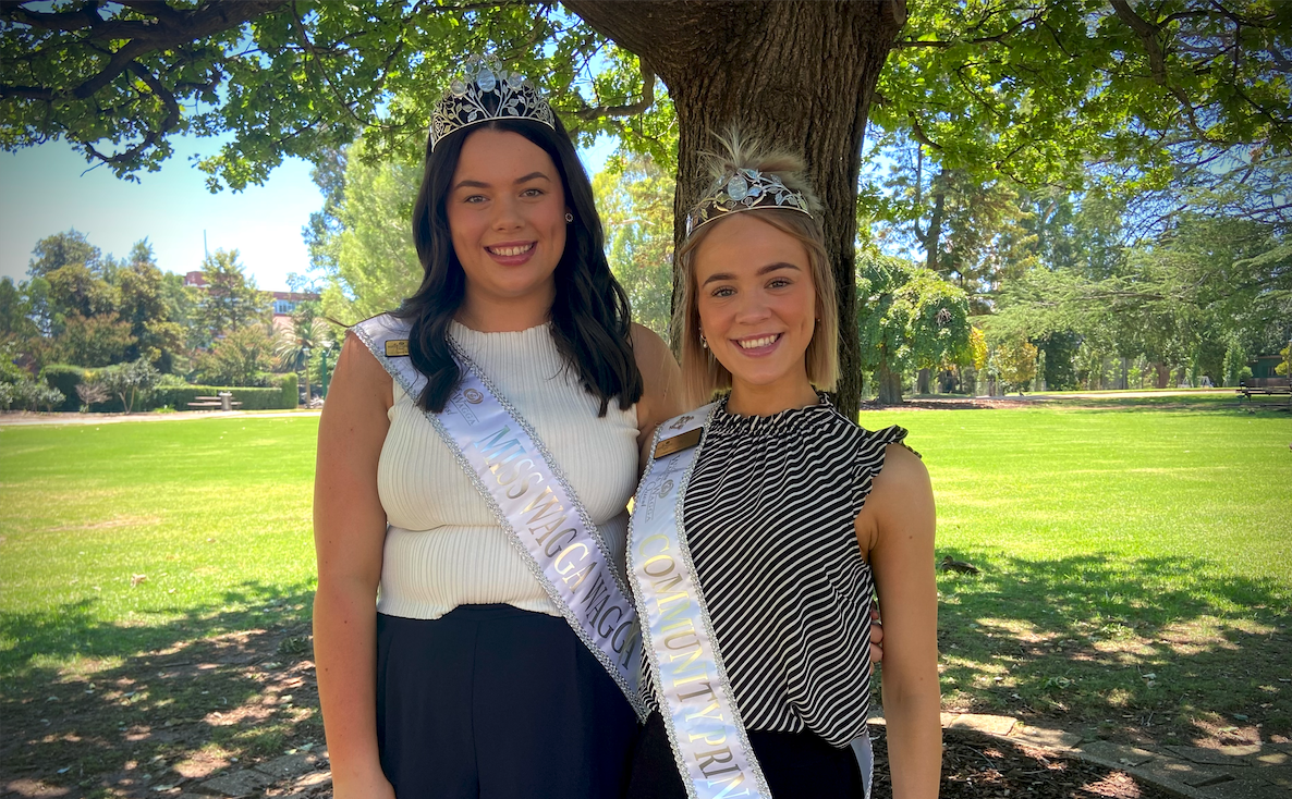 two young women wearing sashes