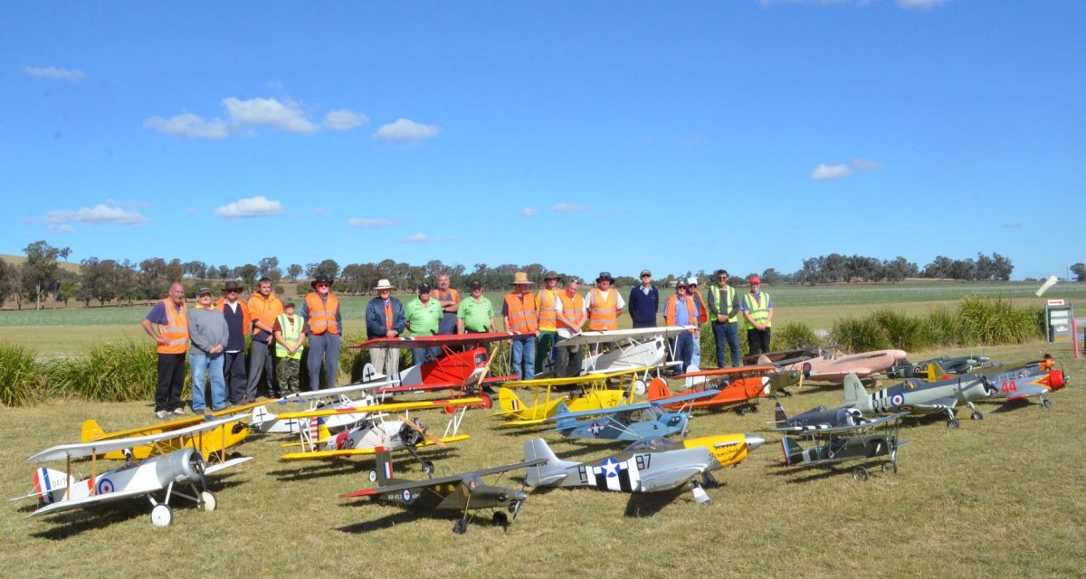 group of model-plane enthusiasts with a display of their handiwork