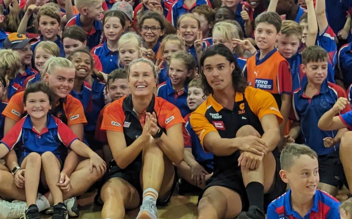 netballers and AFL player with kids