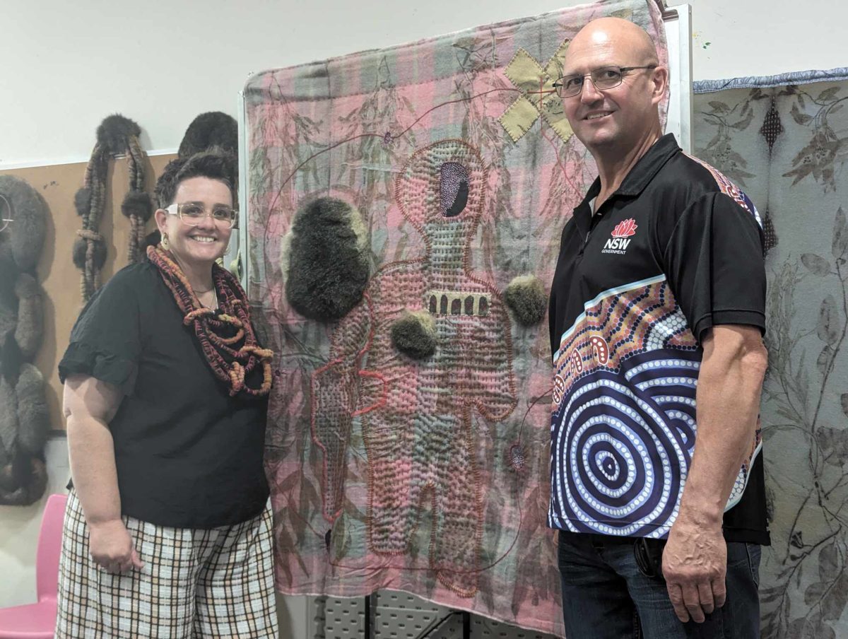 woman and man with Indigenous art