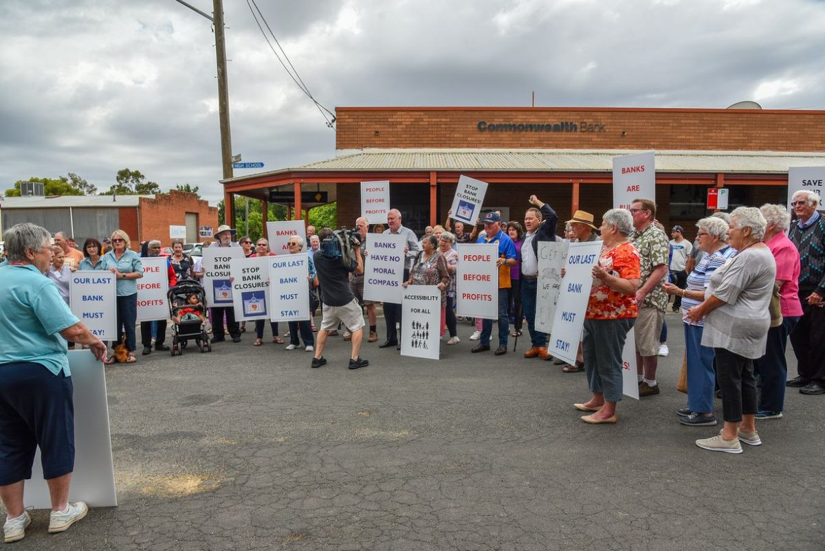 A group of people protesting on the street outside the bank in Junee.